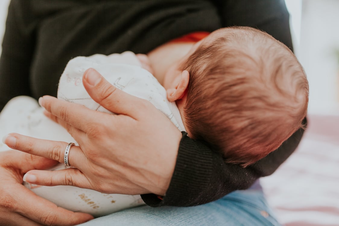 Midsection Of Woman Breastfeeding Baby