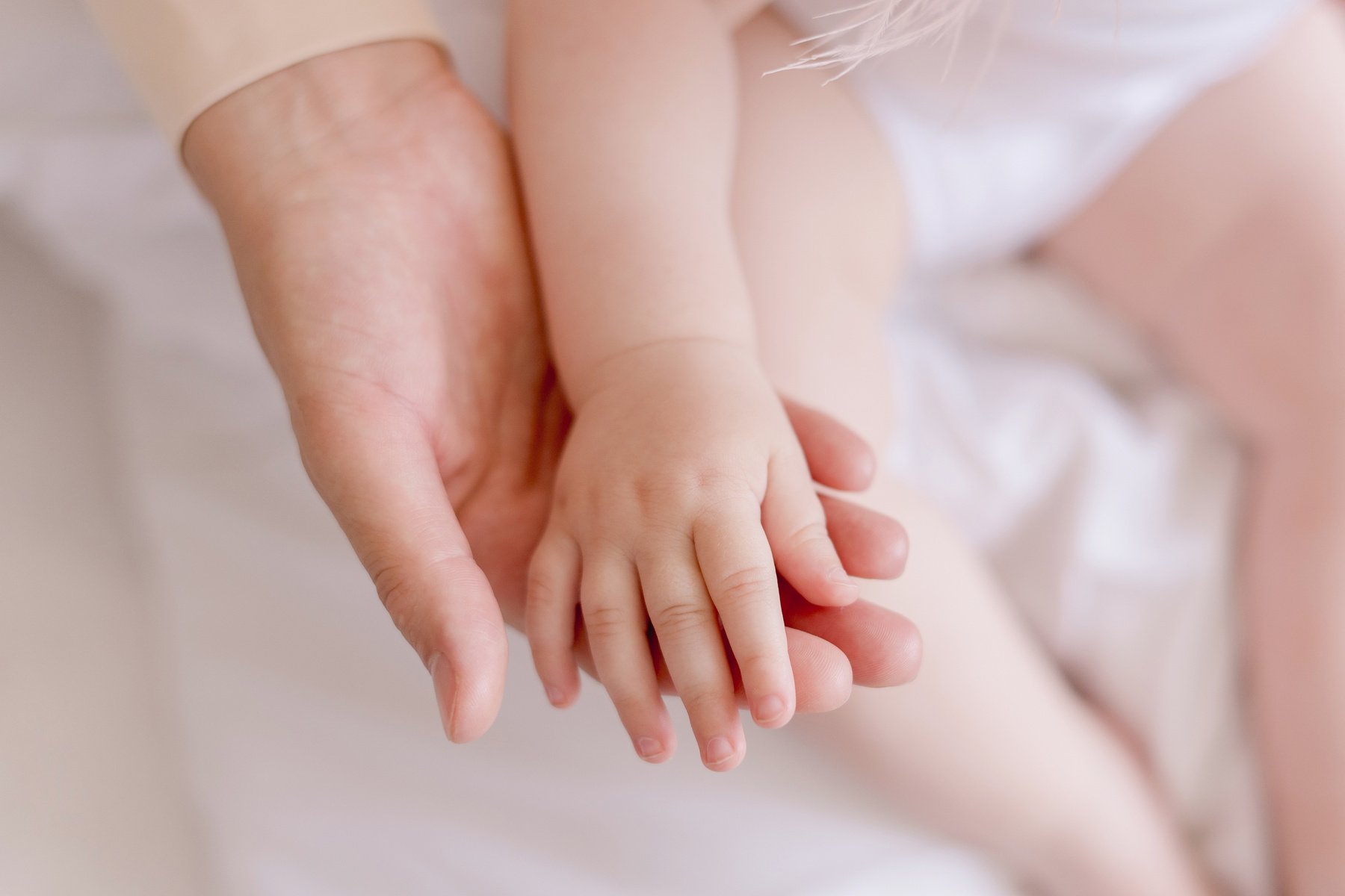 little baby hand in mom's hand